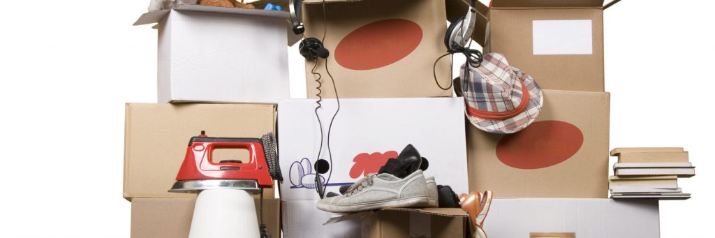cardboard boxes with books, iron, shoes and clothes