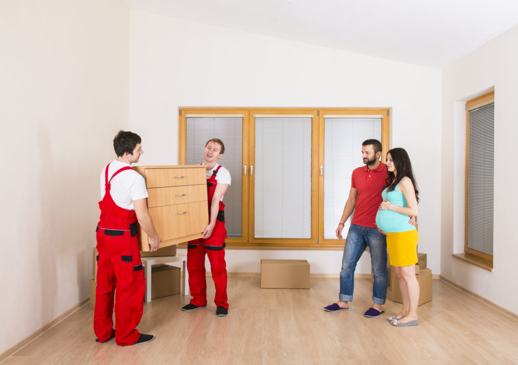 Two movers collecting furniture from a home