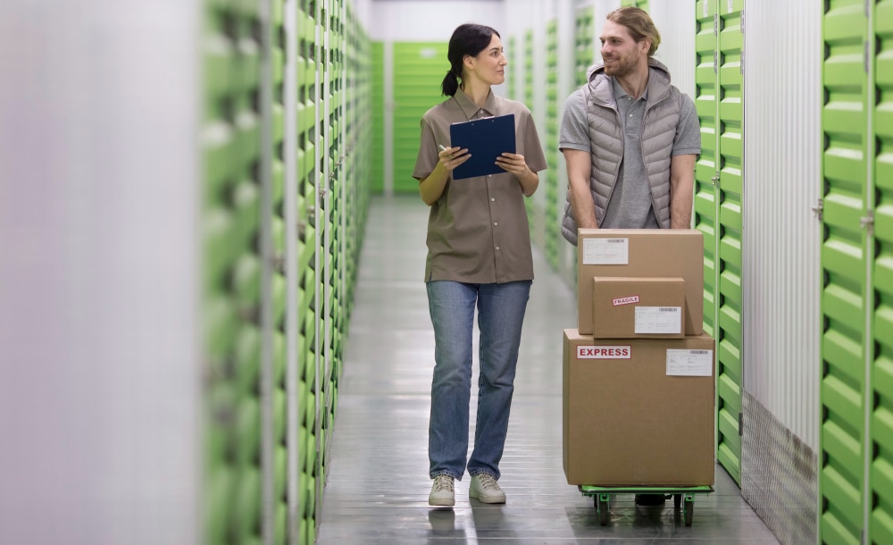 Worker pushing boxes in a self storage facility