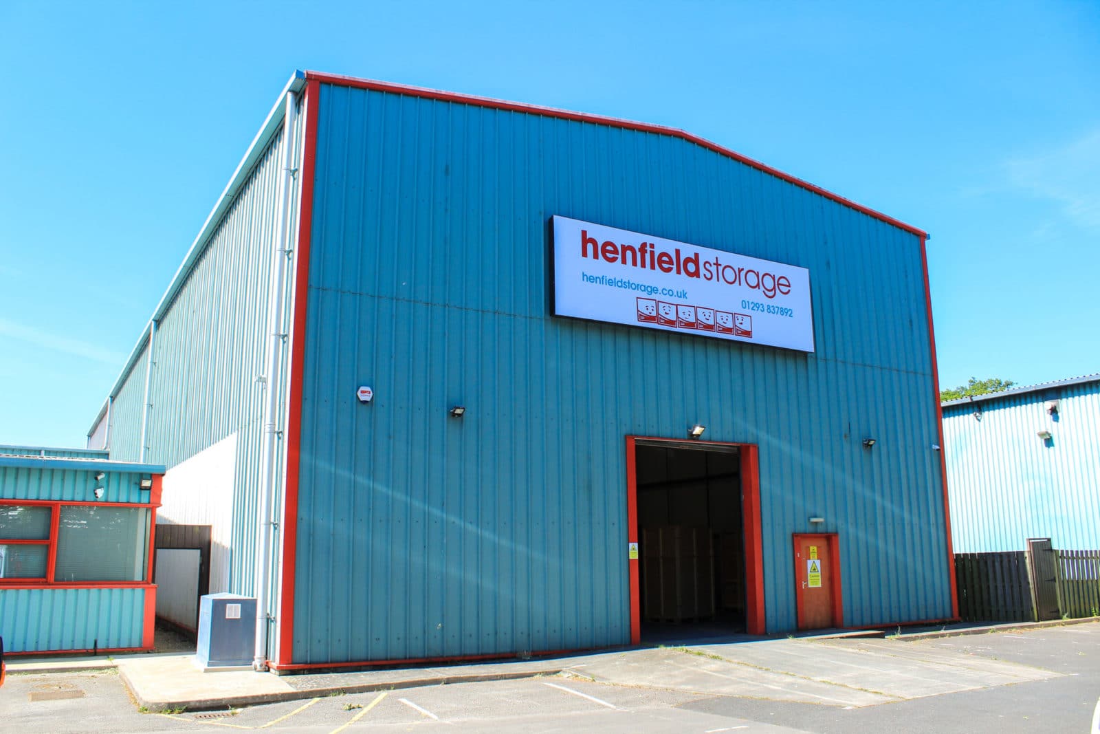 Henfield Storage Crawley warehouse building with red signage and blue exterior