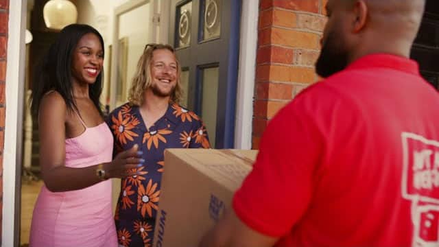 Couple receiving free collection service from Henfield staff at their home